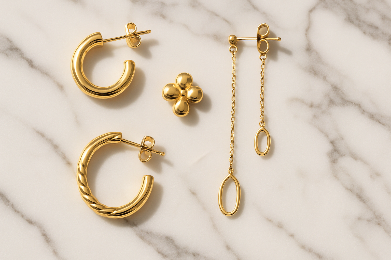 Earrings gold display with a marble background